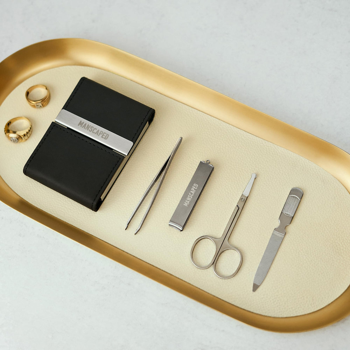 Close-up of MANSCAPED Shears 2.0 tools on a wooden surface