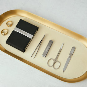 Close-up of MANSCAPED Shears 2.0 tools on a wooden surface