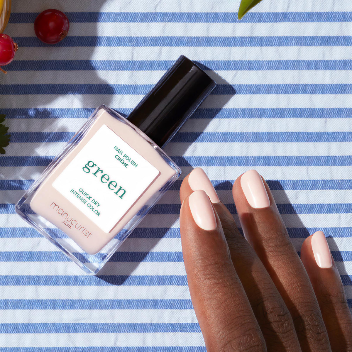 Close-up of Manucurist Green Crème Off-White Nail Polish brush