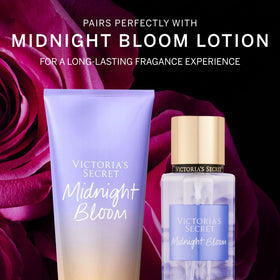 Close-up of Midnight Bloom Mist bottle with floral background