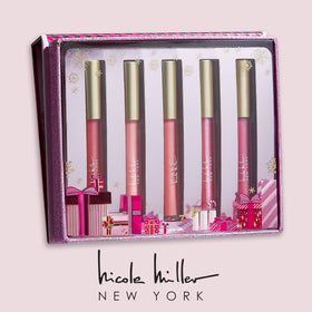 Close-up of Nicole Miller rosy nude lip glosses in clear bottles