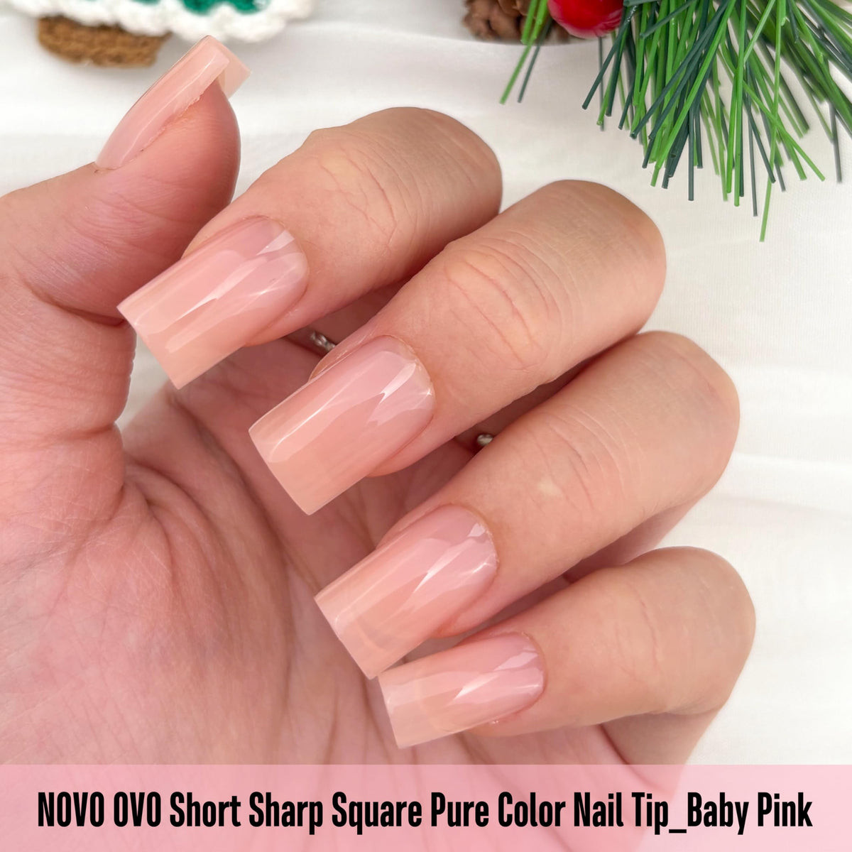 Close-up of NOVO OVO Short Square Nail Tips Baby Pink