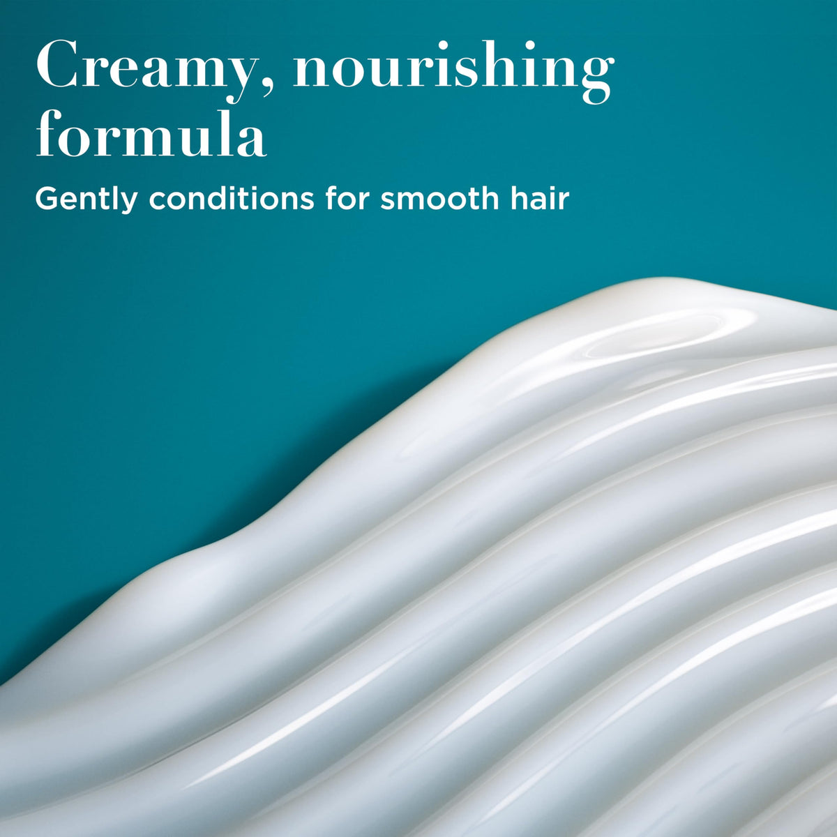 Close-up of OGX Nourishing + Coconut Milk Conditioner bottle