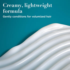 Close-up of OGX Thick & Full Biotin & Collagen Conditioner cap