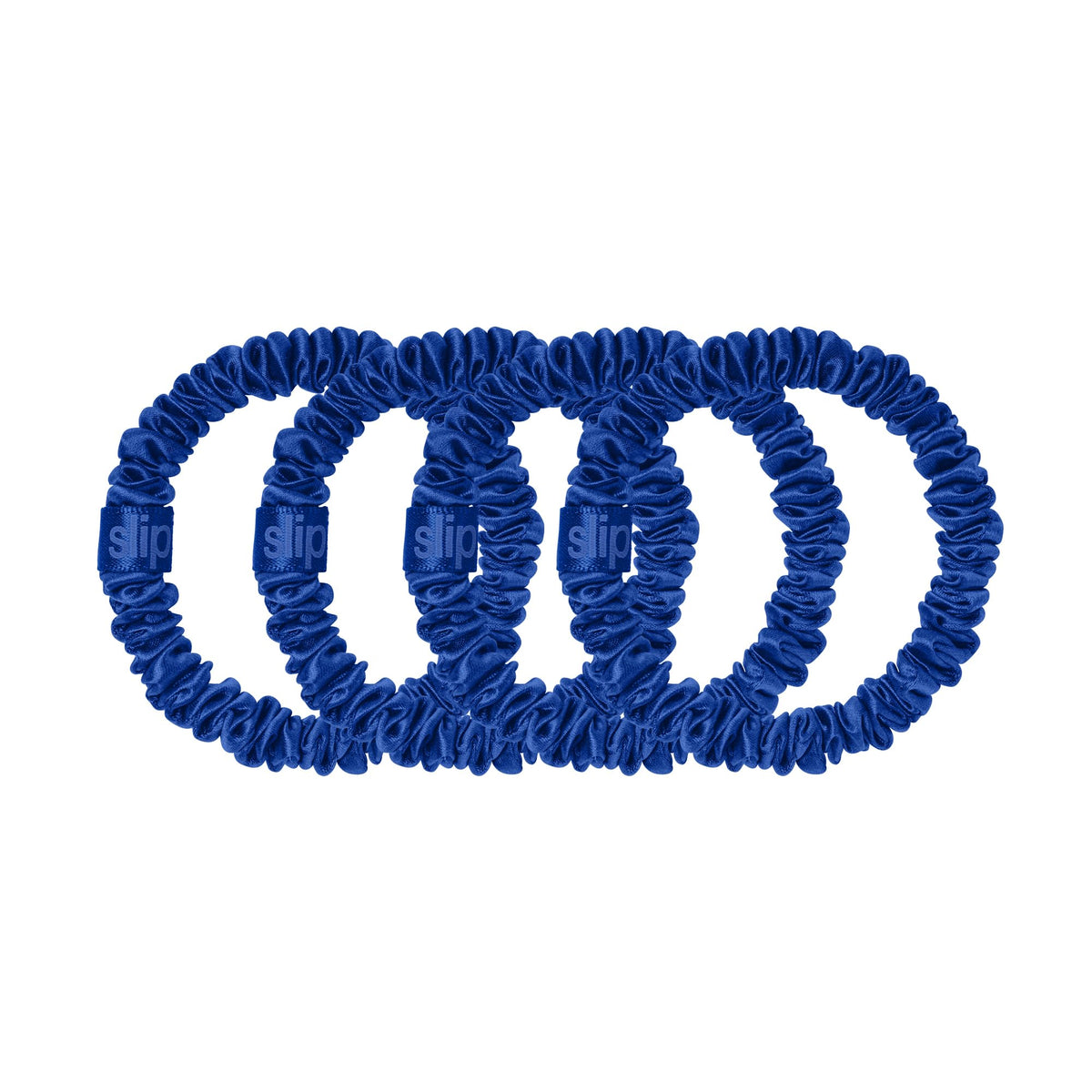 Close-up of SLIP Royal Blue Silk Scrunchies on a white background