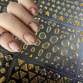 Close-up of SPLOCUDU gold nail stickers in lace and heart patterns