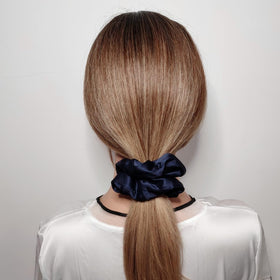Close-up of Sufermoe satin silk hair scrunchie showing texture