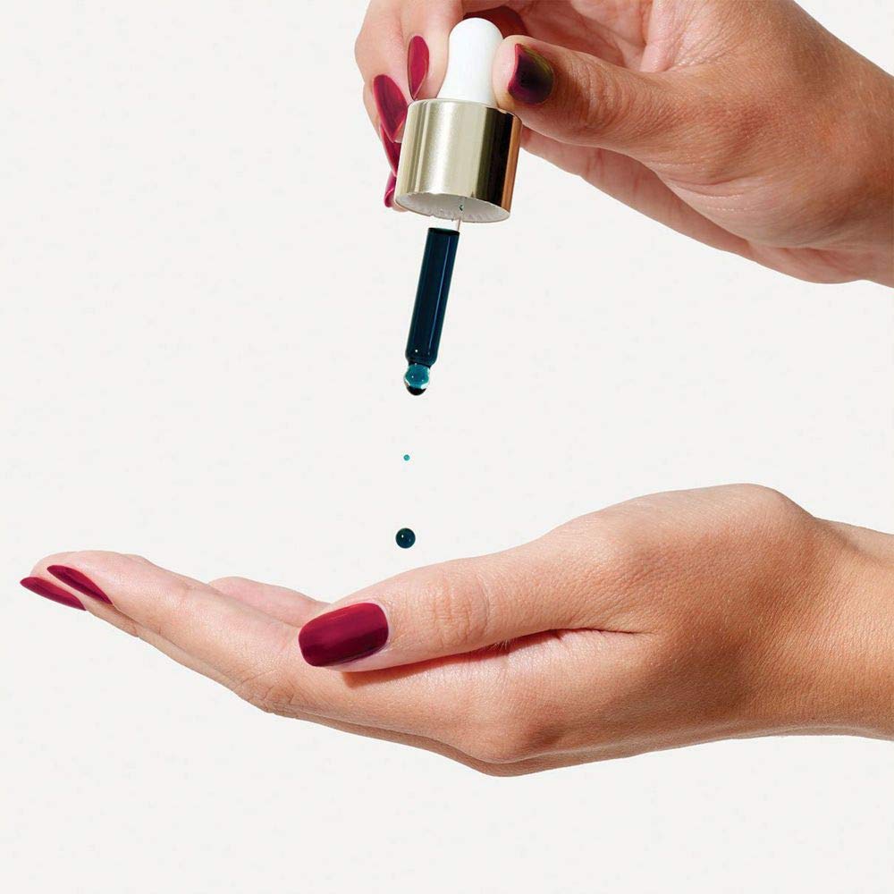 Close-up of Sunday Riley Luna Night Face Oil bottle and dropper