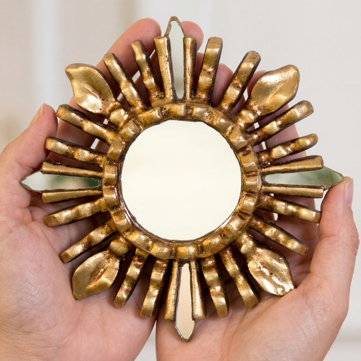 Close-up of the bronze leaf finish on the sunburst mirror