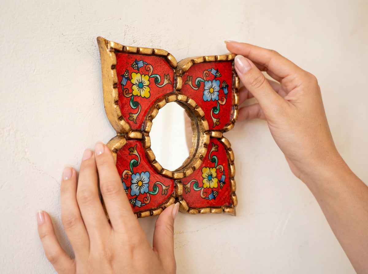 Close-up of the intricate hand-painted floral design on the mirror