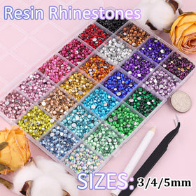 Close-up of TINKRSTUFF rhinestones with tweezers and glue