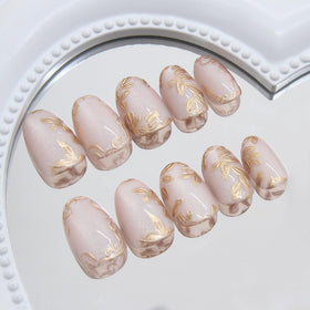 Close-up of XZMeiLun Gold Leaf Press On Nails showing intricate design
