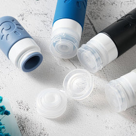 Close-up of Zafit silicone travel bottles with funnel and cleaning brush