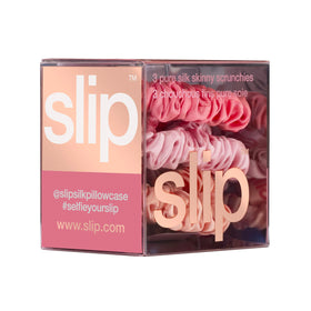Close-up view of blush SLIP silk skinny scrunchie