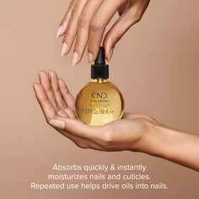 CND SolarOil Cuticle Oil 2.3 oz with floral background