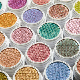 ColourPop Sparkling Hits Super Shock Shadow Trio displayed with other makeup products