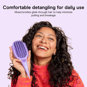 Conair Detangling Brush in use on curly hair