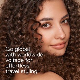 Conair Double Ceramic ½-Inch Curling Iron with claw clip on a vanity
