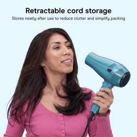 Conair Travel Hair Dryer with compact design next to suitcase