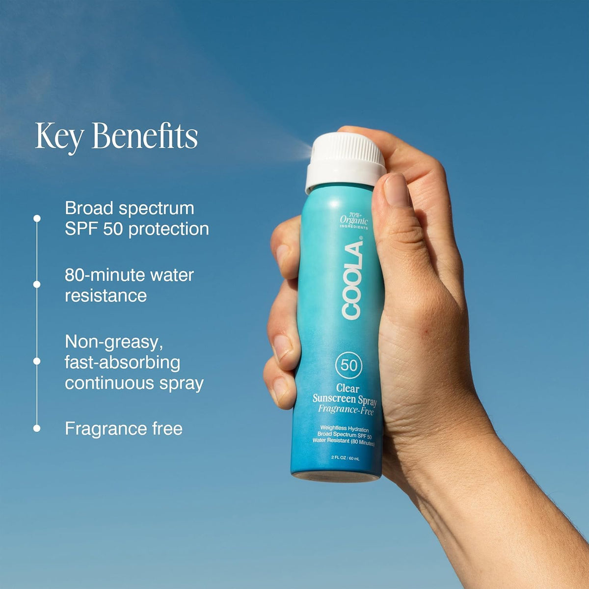 COOLA Clear Sunscreen Spray SPF 50 being applied outdoors