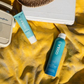 COOLA Face Sunscreen SPF 50 Lotion on a vanity with other skincare products