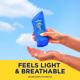 Coppertone sunscreen lotion on a beach towel
