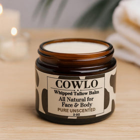 Cowlo Whipped Beef Tallow 2 oz on a bathroom counter