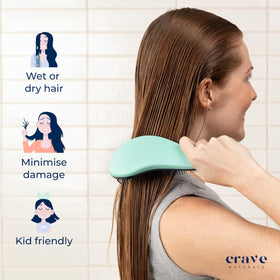 Crave Naturals Biggie Glide Thru Hair Brush on a bathroom counter