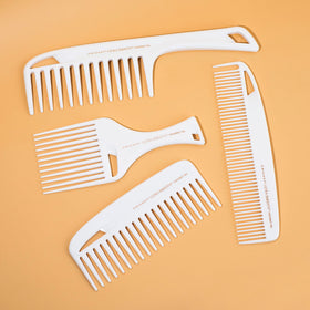 Cricket Ultra Smooth Coconut Dressing Comb in hand for styling