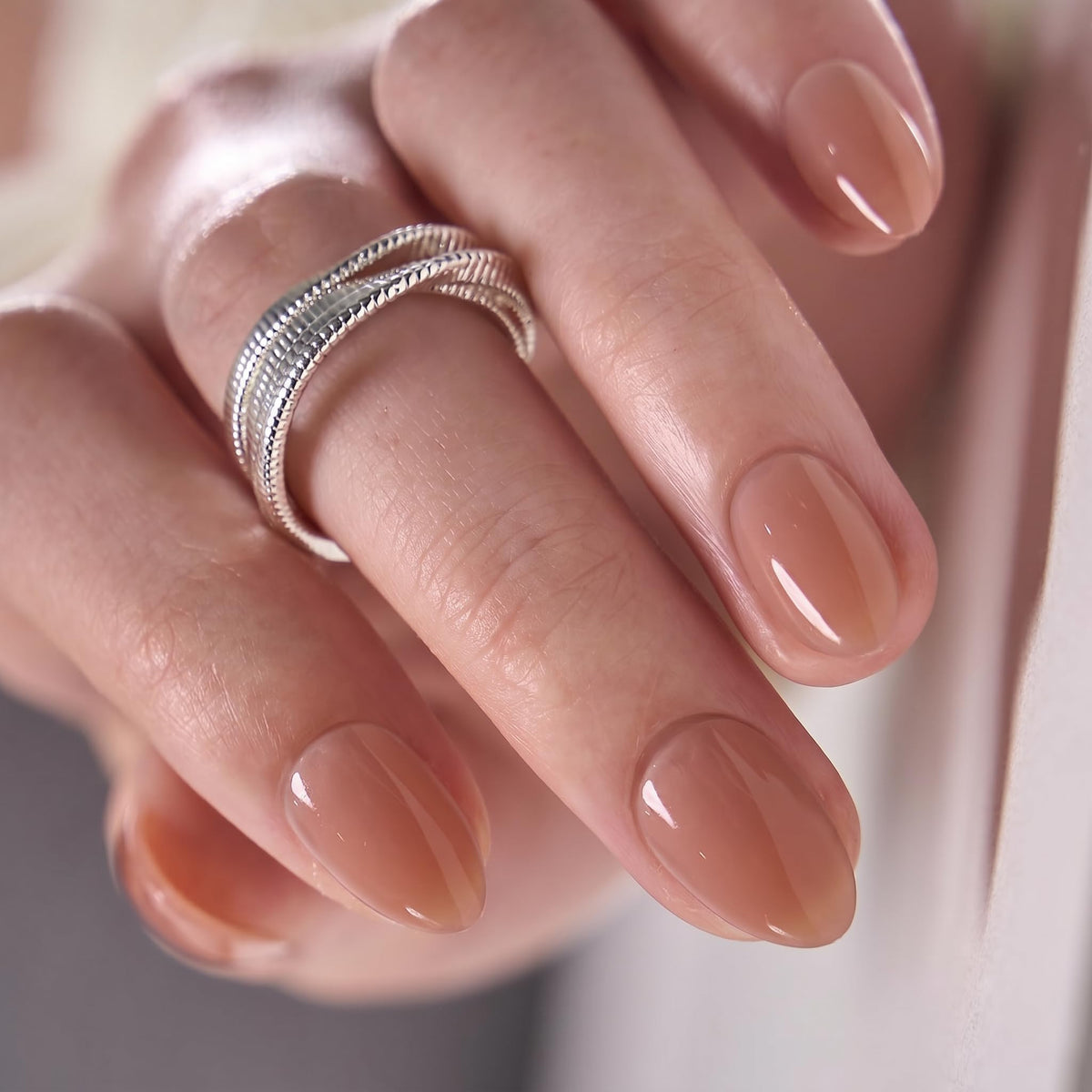 CurvLife Extra Short Almond Press On Nails showing natural fit on a hand