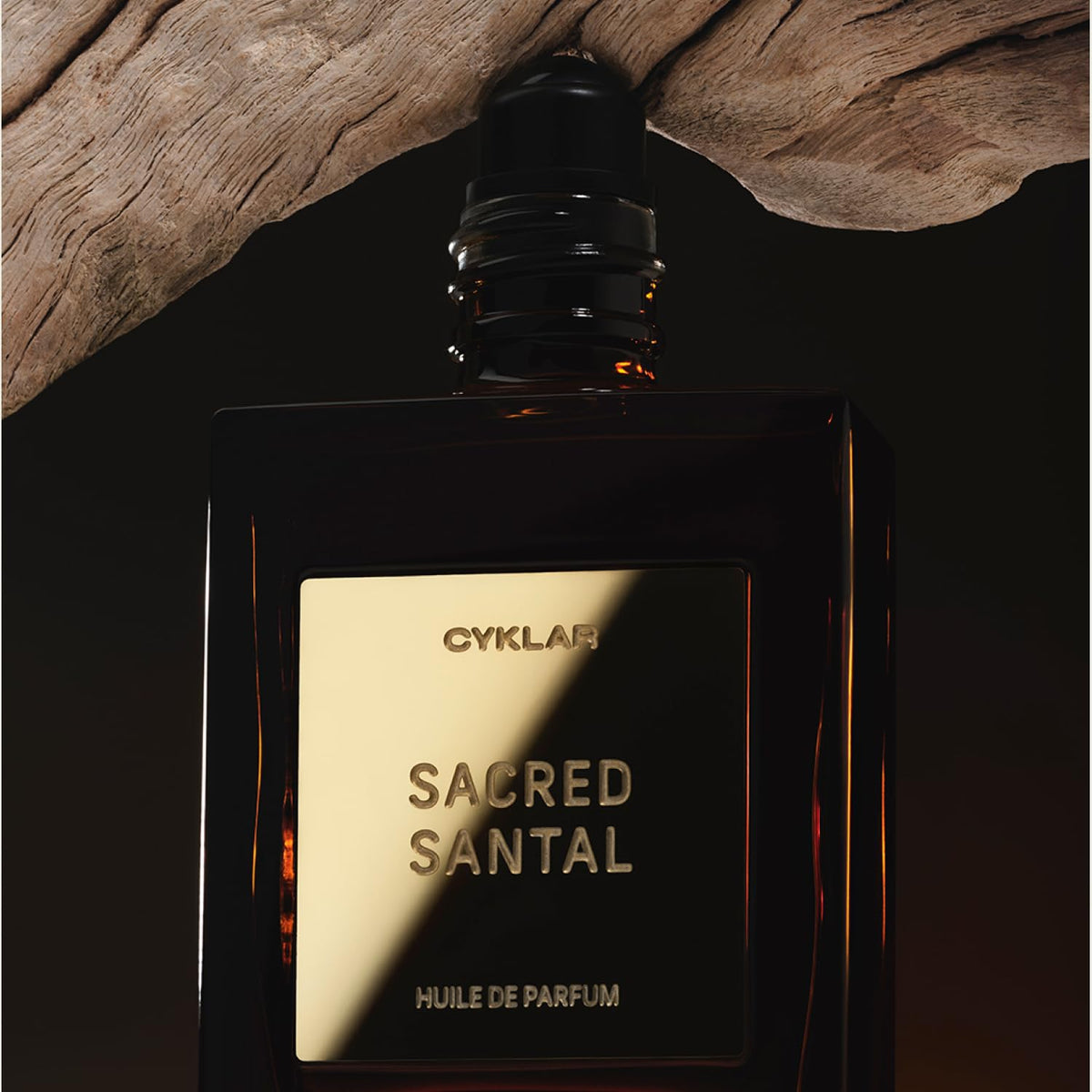 CYKLAR Sacred Santal Perfume Oil with floral background