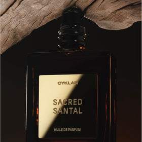 CYKLAR Sacred Santal Perfume Oil with floral background