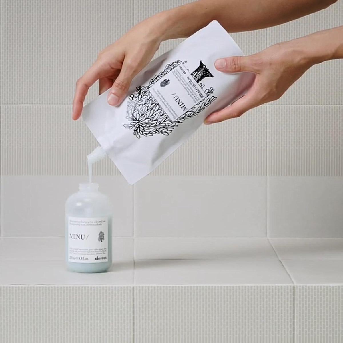Davines MINU Shampoo refill pouch with curly hair