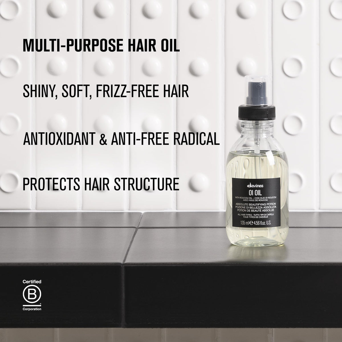 Davines OI Oil in a lifestyle setting with hair styling tools