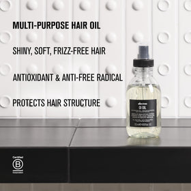 Davines OI Oil in a lifestyle setting with hair styling tools