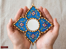 DecorContreras Artisan Small Decorative Mirror hanging on a wall