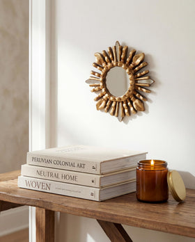 DecorContreras Small Sunburst Mirror displayed in a stylish living room