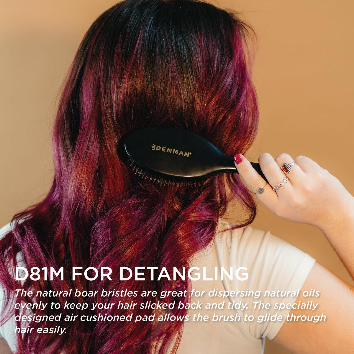Denman Boar Bristle Hair Brush on a vanity with hair products