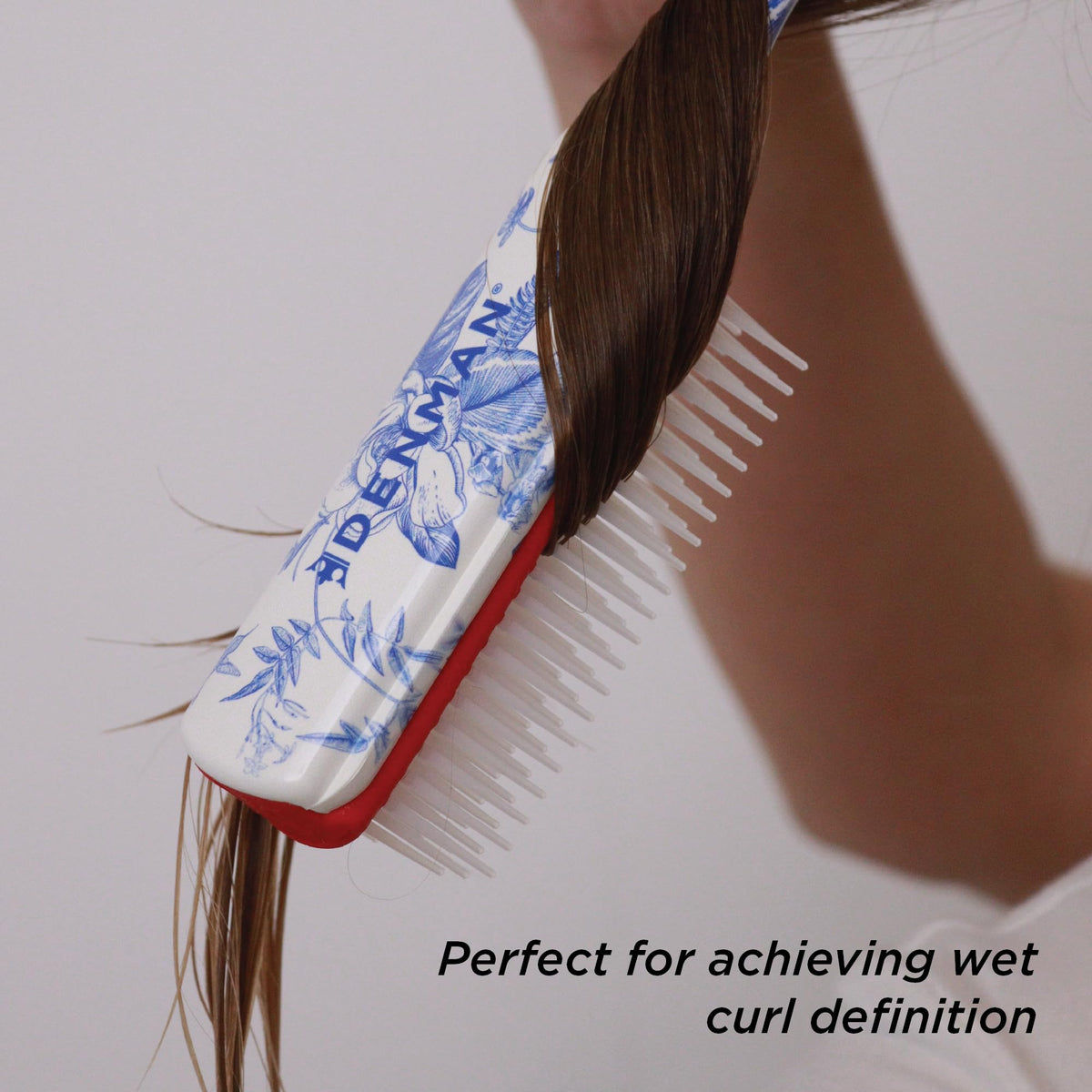 Denman D3 Curly Hair Brush displayed with other hair care tools