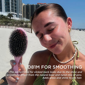 Denman hairbrush demonstrating detangling feature