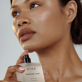 DIME Running Late Perfume lifestyle scene on vanity