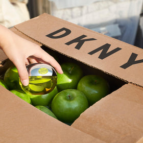 DKNY Be Delicious Eau de Parfum bottle with floral background