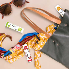 Dmsky lip balm in hand outdoors