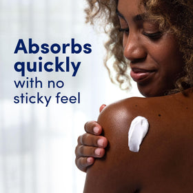 Dove Beauty Cream in a hand, showing rich texture
