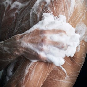 DOVE MEN + CARE Charcoal + Clay Body Wash in a shower setting