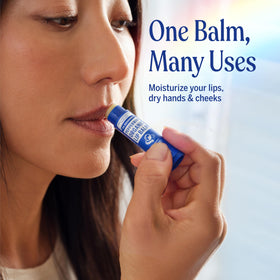 Dr. Bronner's Organic Lip Balm Peppermint next to fresh mint leaves