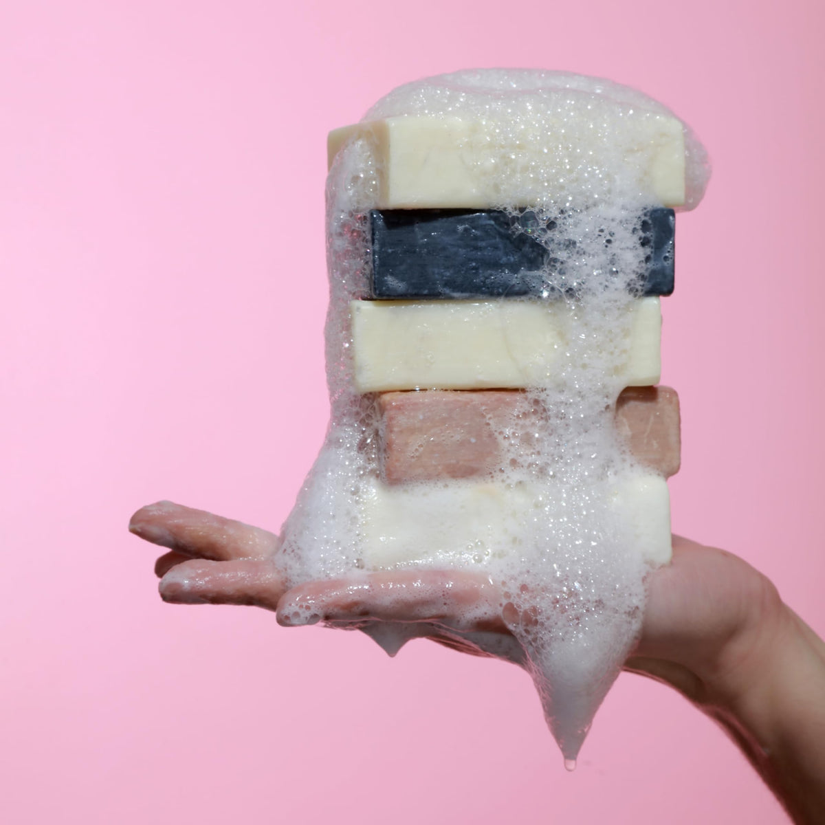 Dr. Natural Black Bar Soap in a hand washing scenario