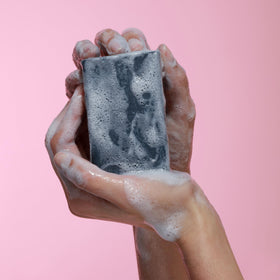 Dr. Natural Black Bar Soap with water droplets