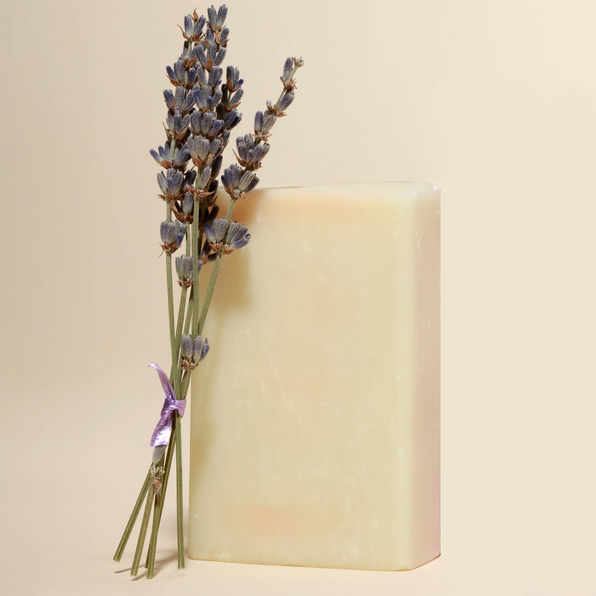 Dr. Natural Castile Bar Soap Lavender beside a sink