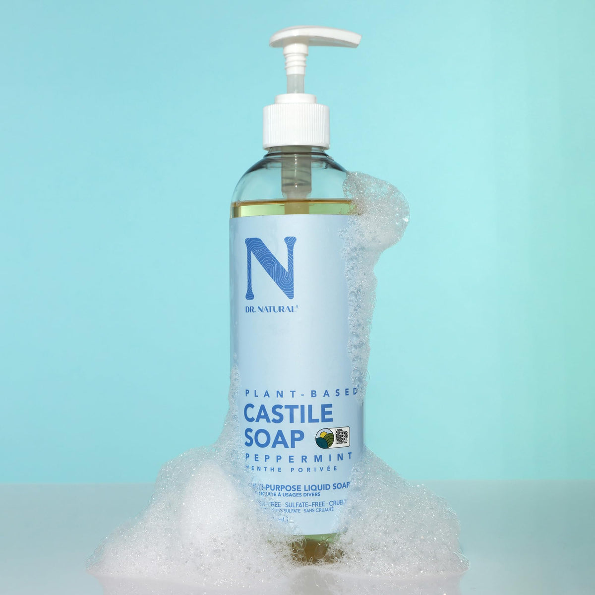 Dr. Natural Castile Liquid Soap 16 oz peppermint pouring into hands